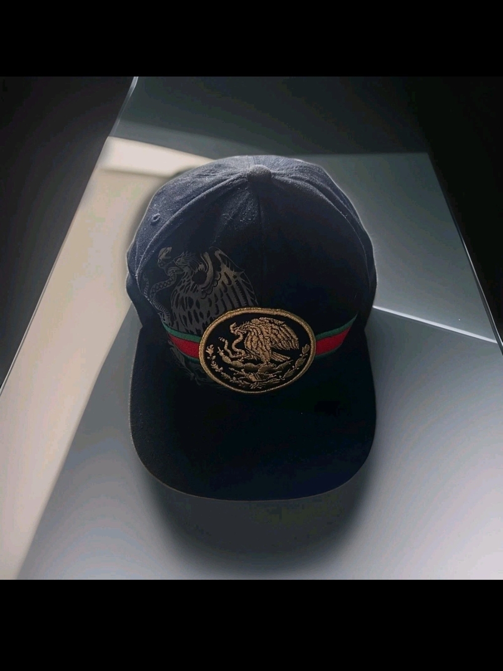 Black Baseball Cap with Gold Emblem and Red-Green Stripe